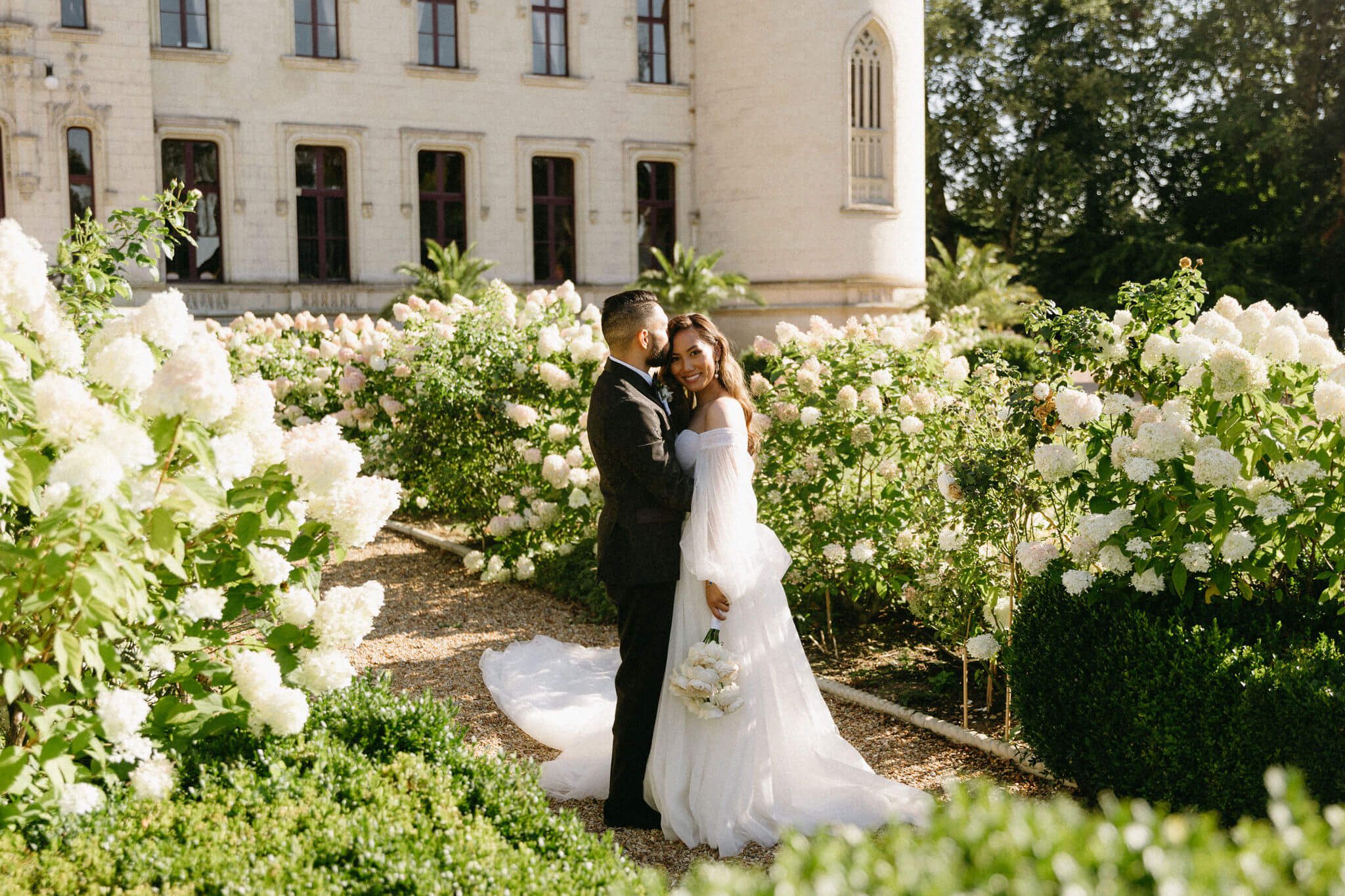 romantic wedding couple in gardens of Chateau Challain