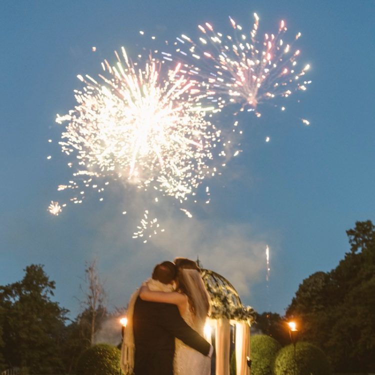 couple enjoying fireworks at their luxury wedding packages